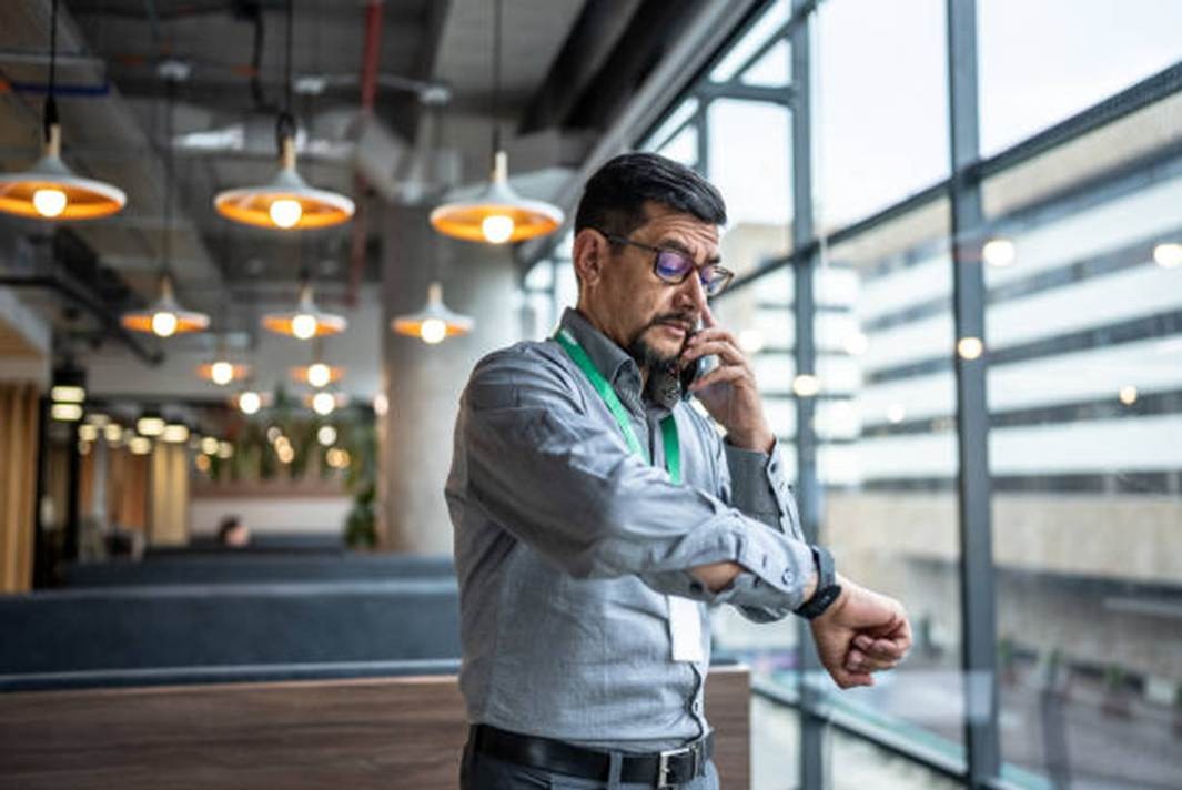 Employee checking time at work with smart attendance tools