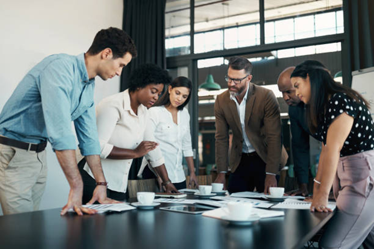 Team members discussing work around a conference table