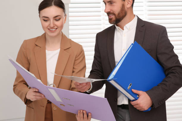 Two people looking at a folder