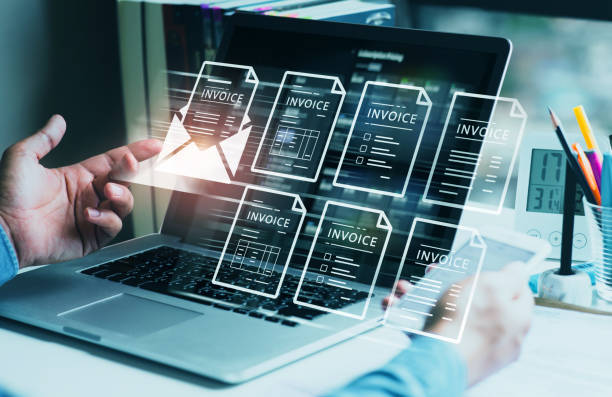 Person looking at laptop with invoice holograms