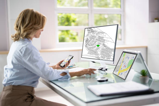 Employee working on a laptop at a desk with a map displayed on the screen