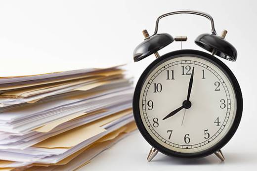 Alarm clock and documents showing payroll integration