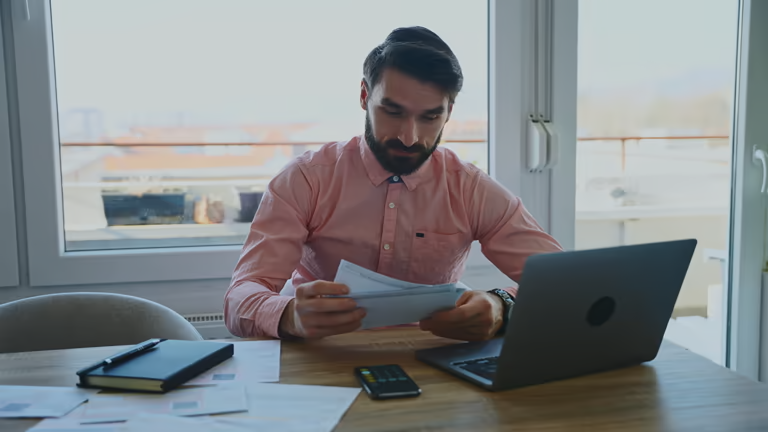 Man reviewing papers at desk
