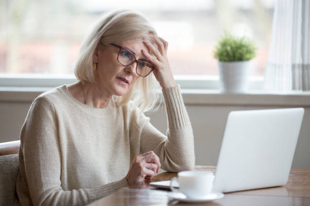 Confused woman looking at laptop