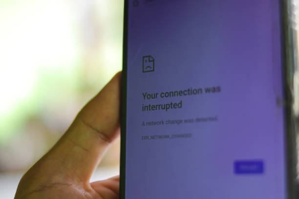 Hand holding a phone showing connection interrupted error