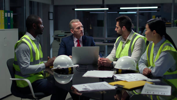 Team meeting in an office with construction gear