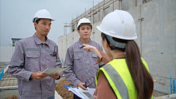 Supervisor talking to workers on construction site