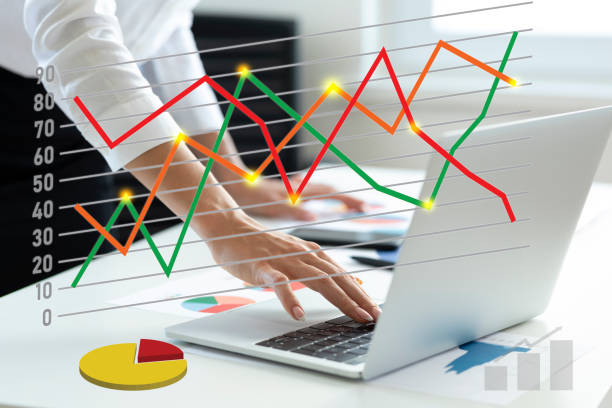 Laptop with superimposed line chart for cost management
