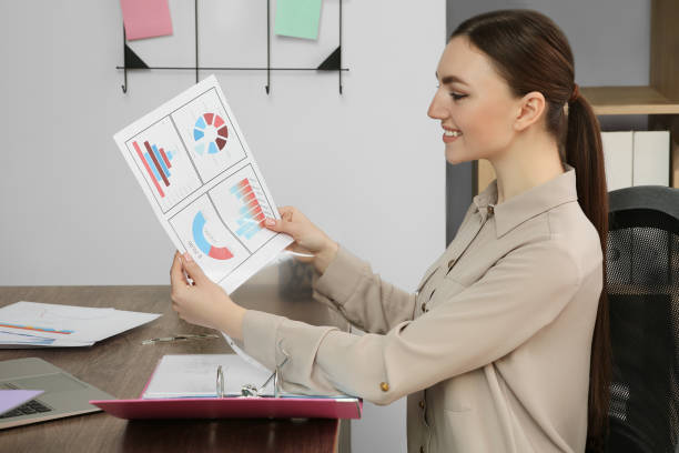 Woman analyzing charts at desk