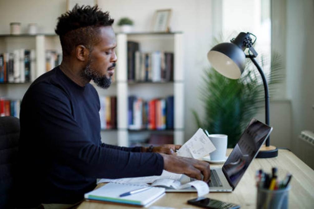 Employee reviewing payroll reports on a laptop