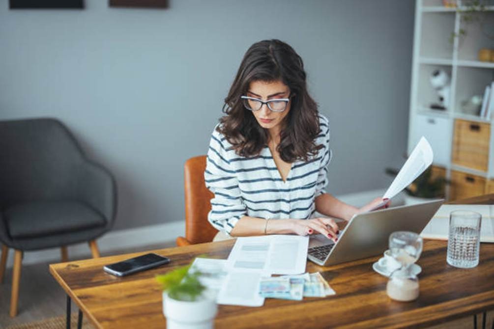 Manager using laptop to review custom payroll reports