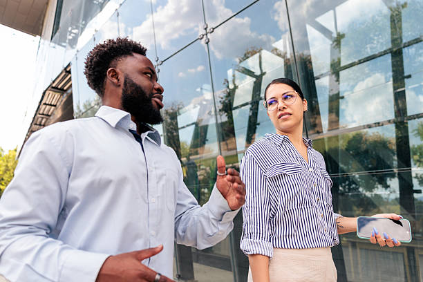 Two people discussing and looking at a phone
