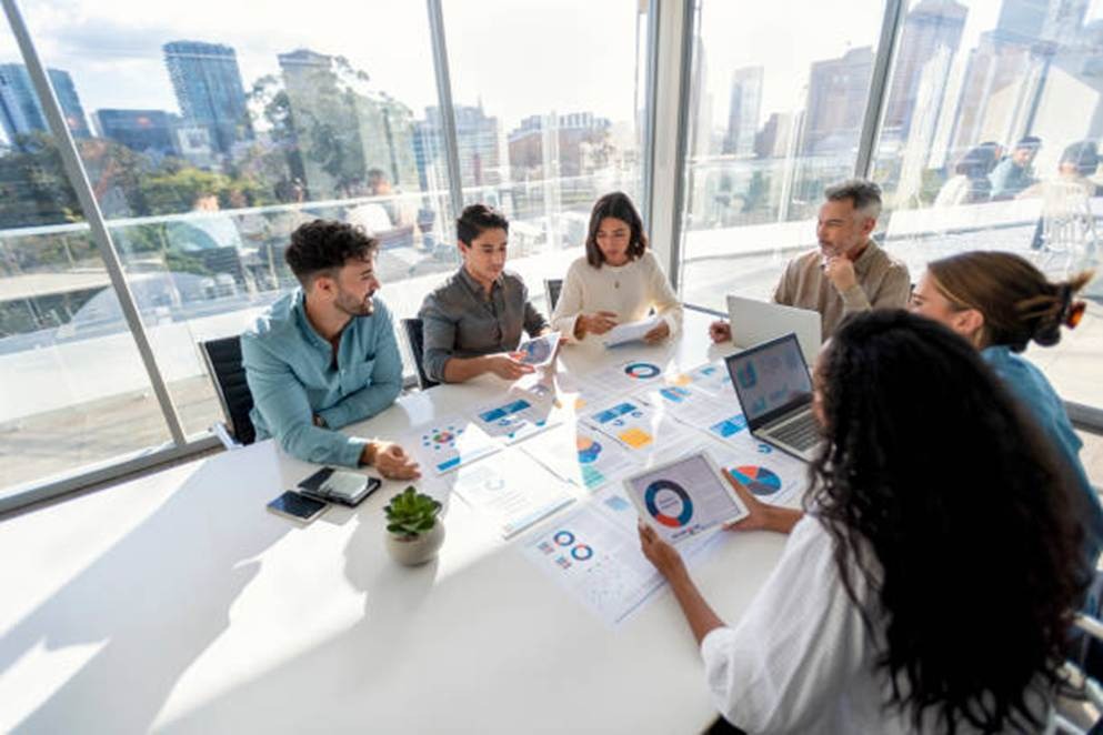 Business team meeting using reports for training and skill building