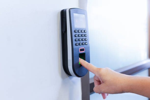 Employee using fingerprint scanner terminal