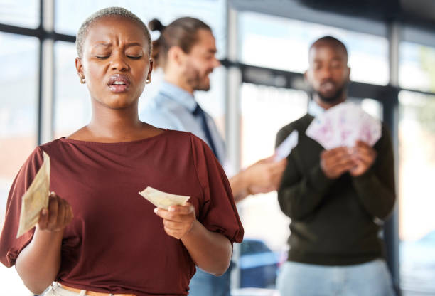 Confused employee looking at payroll money