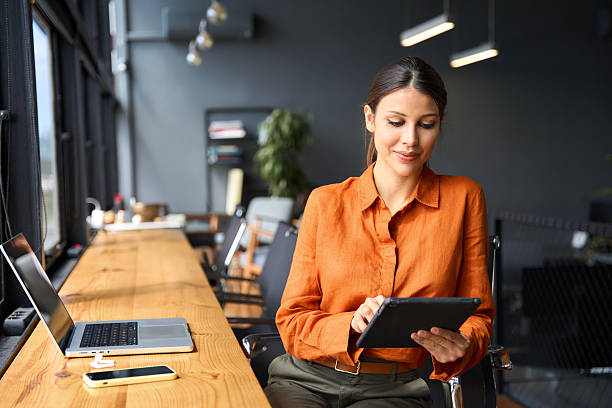 Woman looking at a tablet at her desk