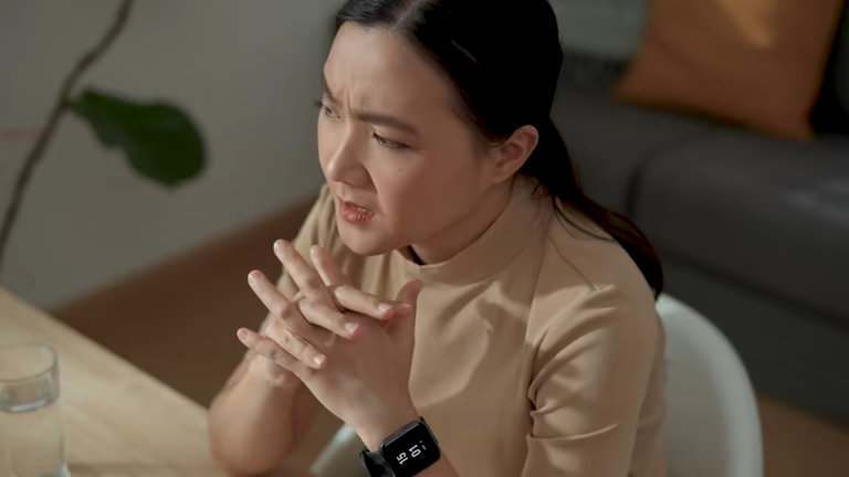 Frustrated employee looking at her smartwatch