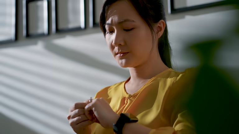 Woman checking her watch near a window
