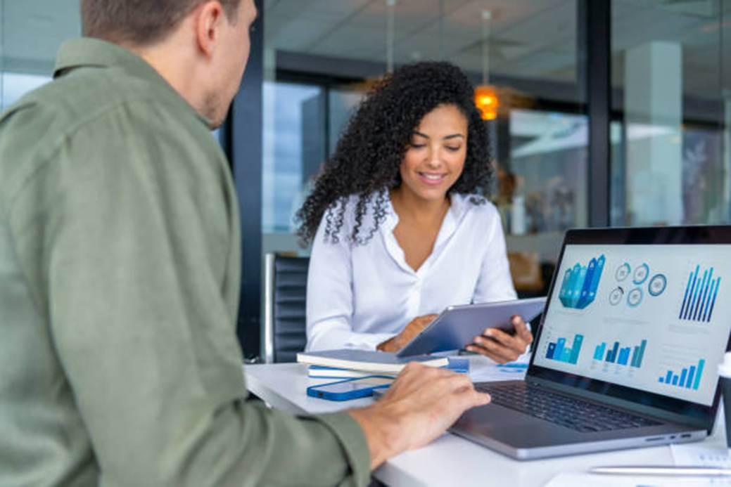 Employees reviewing analytics and behavioral insights on a laptop