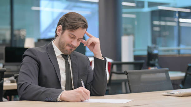 Man looking stressed at desk