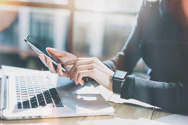 Employee using laptop and phone