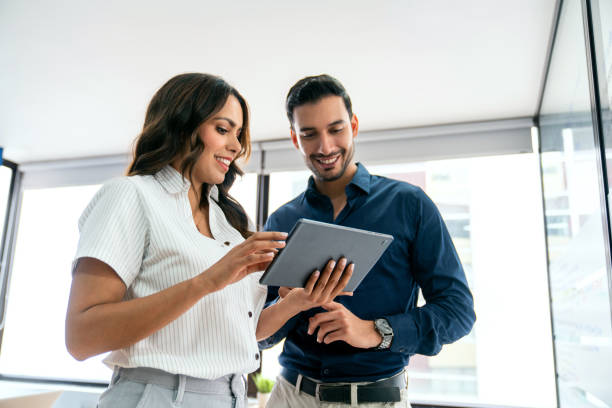 Two employees looking at a tablet together