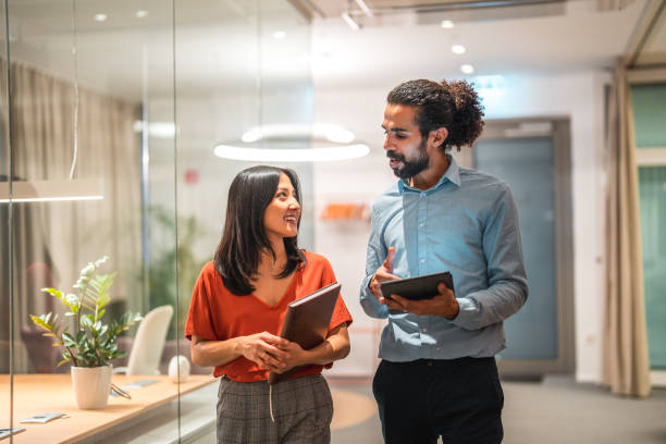 Two employees discussing exception handling in the office