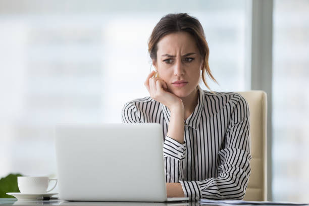 Stressed woman looking at laptop