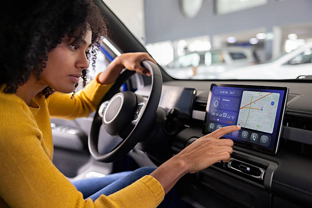 Woman sitting in car using dashboard screen