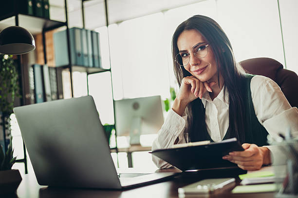 Woman smiling with arms crossed in an office