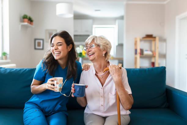 Caregiver and elderly client sitting on a couch