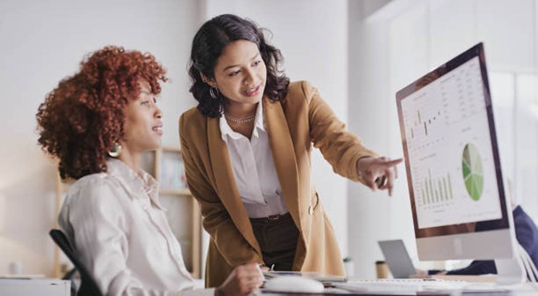 Managers reviewing workplace performance data on a computer