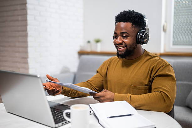 Man with headphones working on a laptop