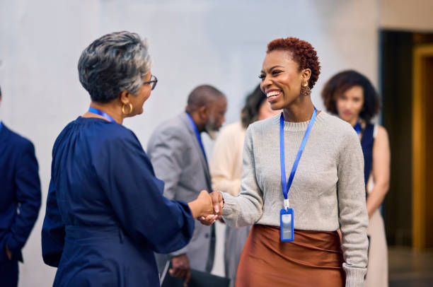Two women shaking hands in the office