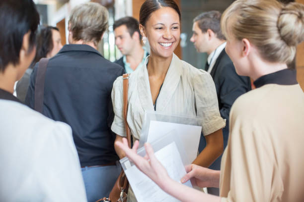 Group of diverse employees talking in a hallway
