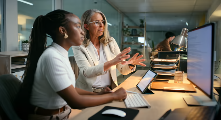 Two women looking at a computer monitor