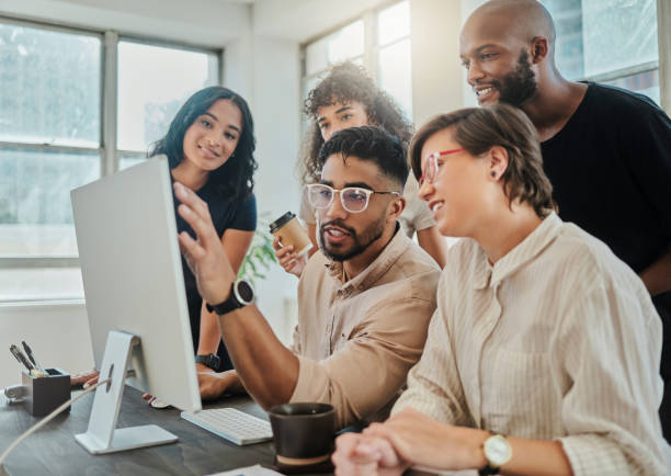 Diverse group of people looking at a computer screen