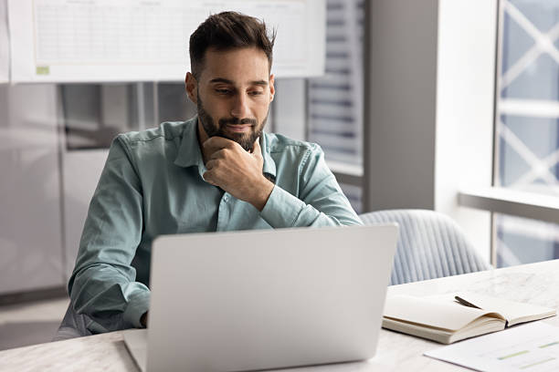 A man looking at a laptop