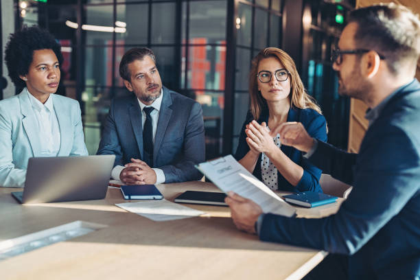 Professionals in a meeting discussing time data