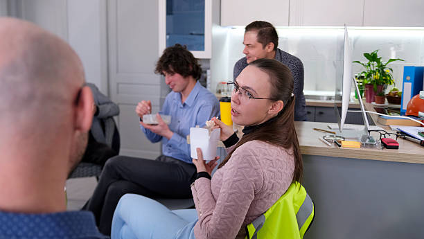 People sitting and eating out of containers