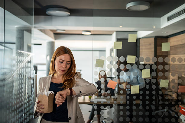 A woman looking at a board with sticky notes