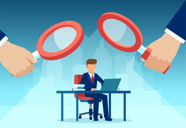 Magnifying glasses looking at a person sitting at a desk
