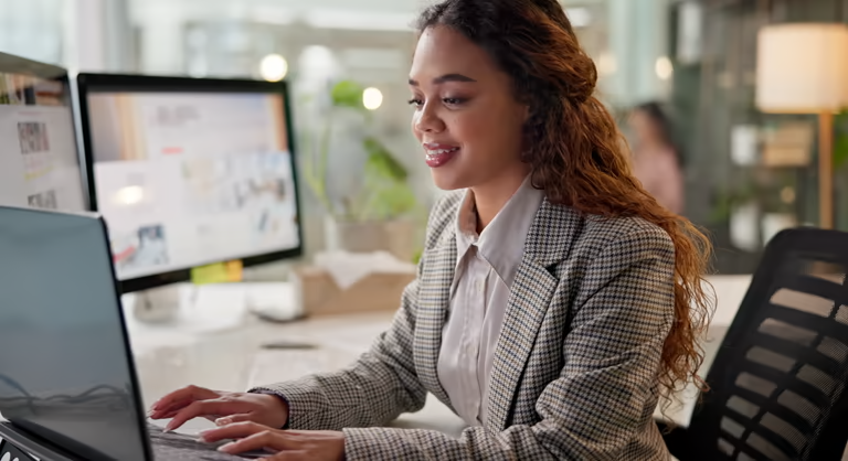 Woman working on a laptop in an office