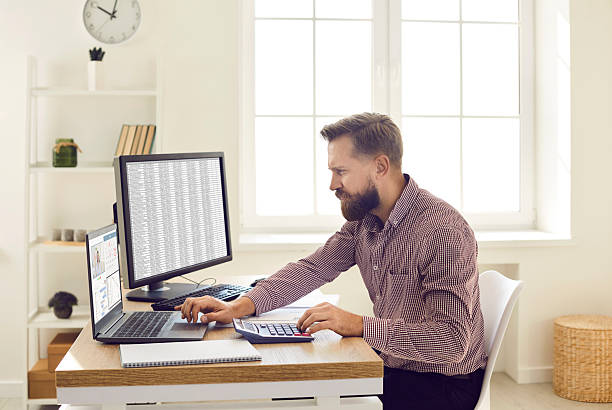 Supervisor reviewing payroll on computer