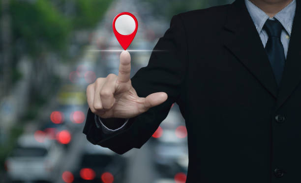 Hand touching screen with GPS location pin