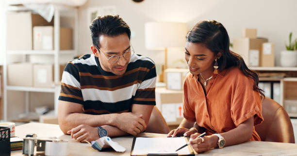 Two people looking at a laptop