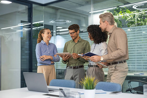 Group of people standing and looking at a laptop