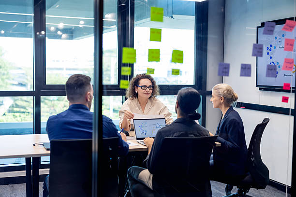 People in a meeting room discussing HR systems