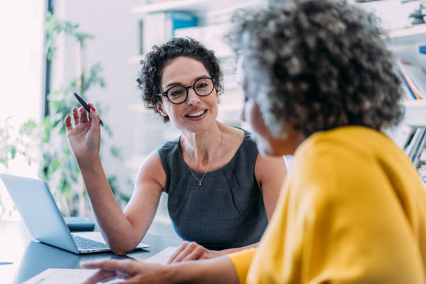 Two women discussing software simplicity vs complexity