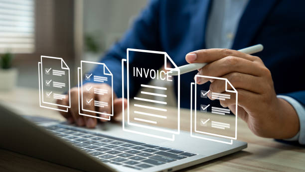 Person holding pen over an invoice document